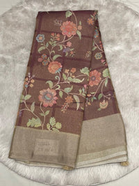 Deep plum-toned Muslin Tissue saree with large floral vine motifs and a shimmering solid gold border.