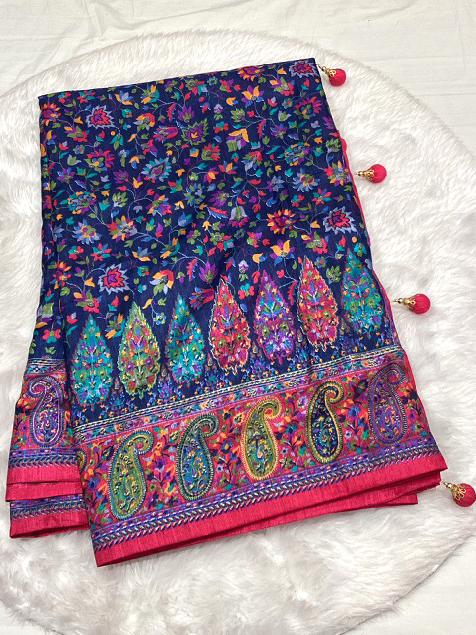 Navy Blue Dola Silk Saree featuring traditional Patola artwork and a bright pink Zari border with corner tassels.