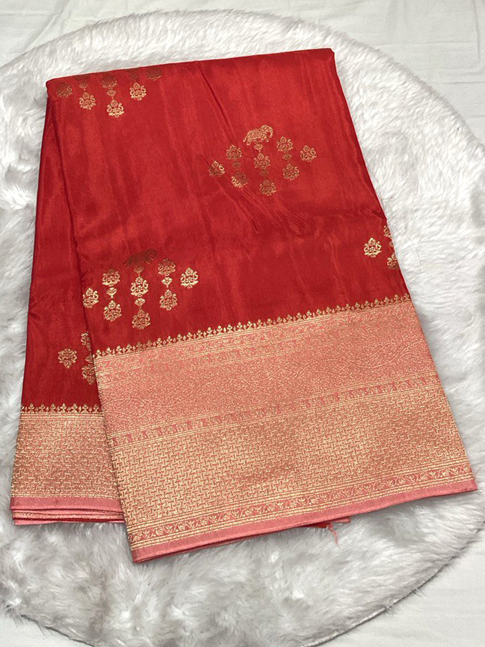 Tomato red Raw Mango Silk saree with gold woven elephant buttas and a broad Zari border.