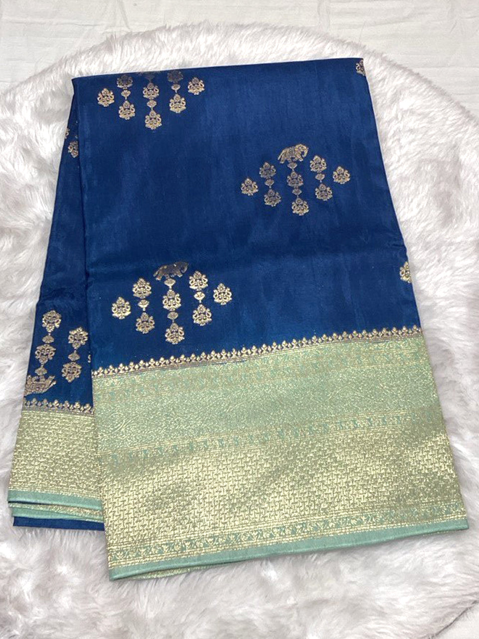 Royal blue Raw Mango Silk saree featuring contrast gold and silver Zari weaving with traditional motifs.