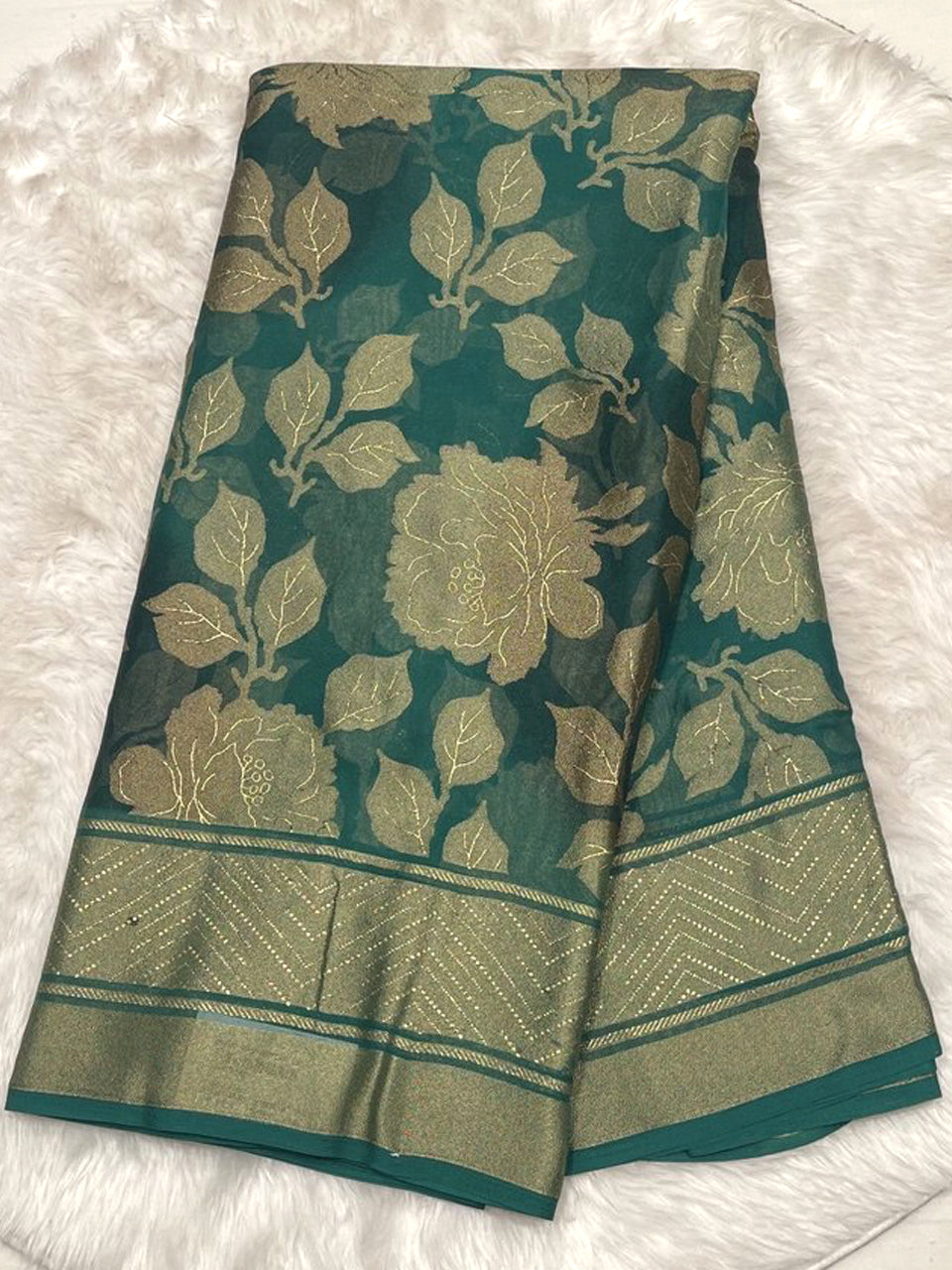Elegant teal green Russian georgette braso saree with shimmering floral motifs and a designer printed blouse.