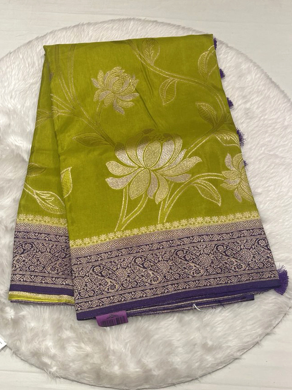 Olive green Russian viscose saree featuring a purple paisley border and woven flower patterns.