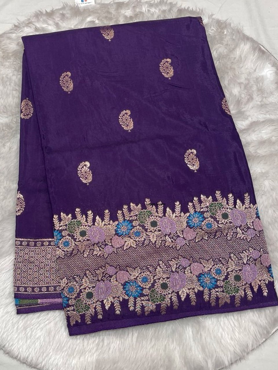Luxurious royal purple Samurai Satin saree with a heavy gold zari border accented with colorful floral embroidery.