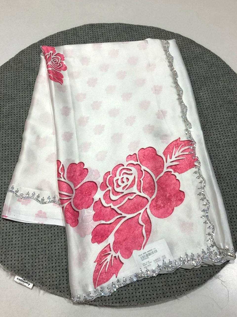 Smooth satin crepe saree featuring a vibrant high-definition digital floral print with a glossy finish and fluid drape.