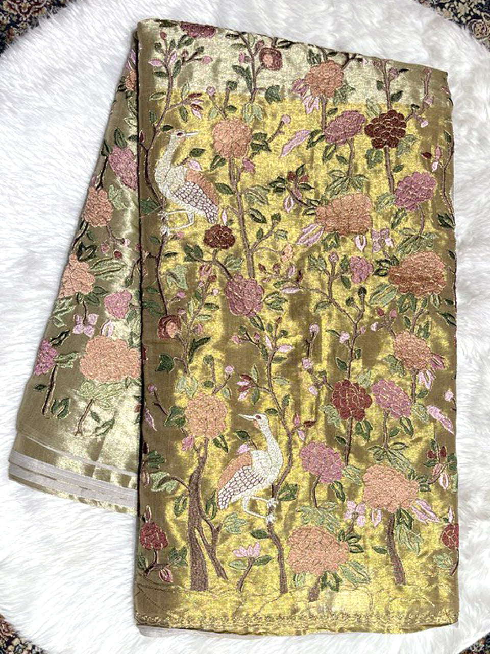 Shimmering gold tissue Paithani saree featuring intricate multi-color thread work with crane and floral garden motifs.