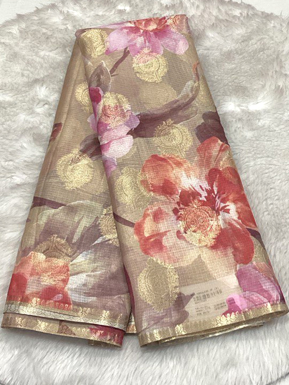 Beige Semi Silk Kota saree with peach and red floral prints, gold foil circular accents, and a thin gold border.