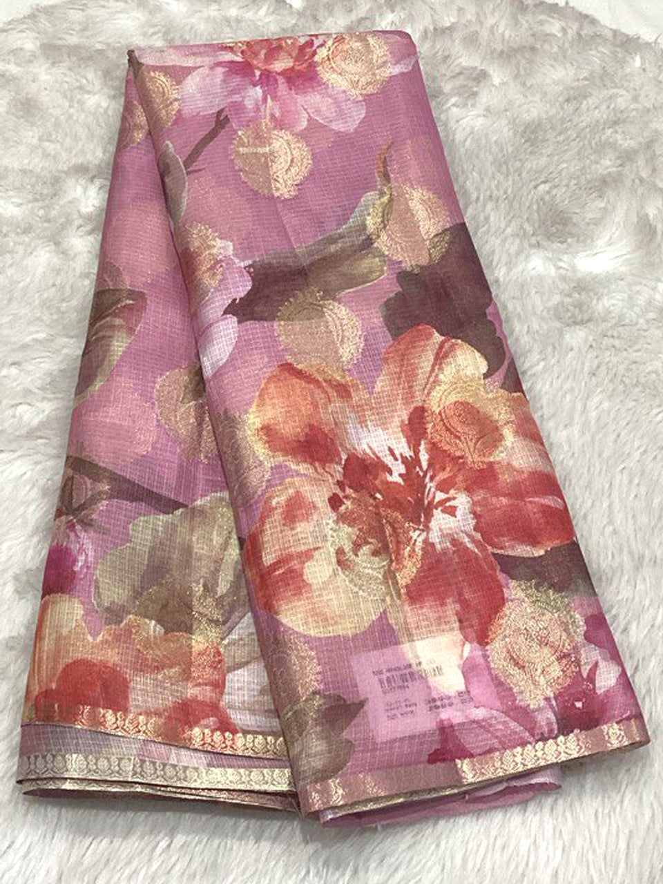 Onion pink Semi Silk Kota saree featuring large rose-colored floral designs and metallic gold highlights.
