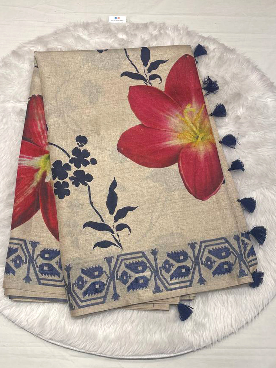Elegant beige semi Tussar silk saree with red floral patterns and a navy blue weaving leaf work border.