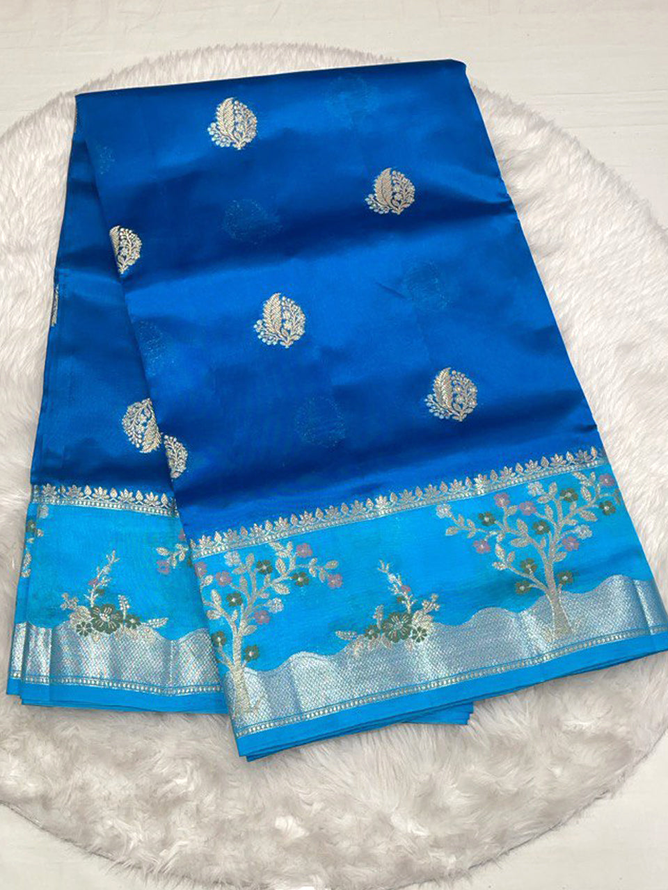 Bright blue pure silk saree with sky blue scalloped border and gold zari.