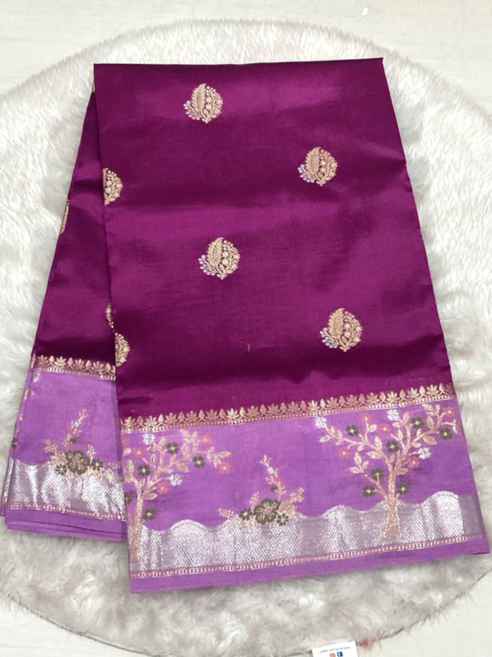 Rich magenta silk saree with a lavender purple border and tree embroidery.