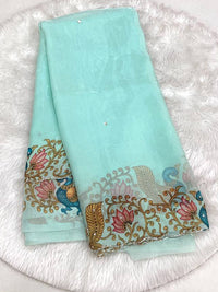 Seafoam aqua space silk saree featuring a multicolored designer cutwork border with peacock and lotus floral prints and small bead butas.