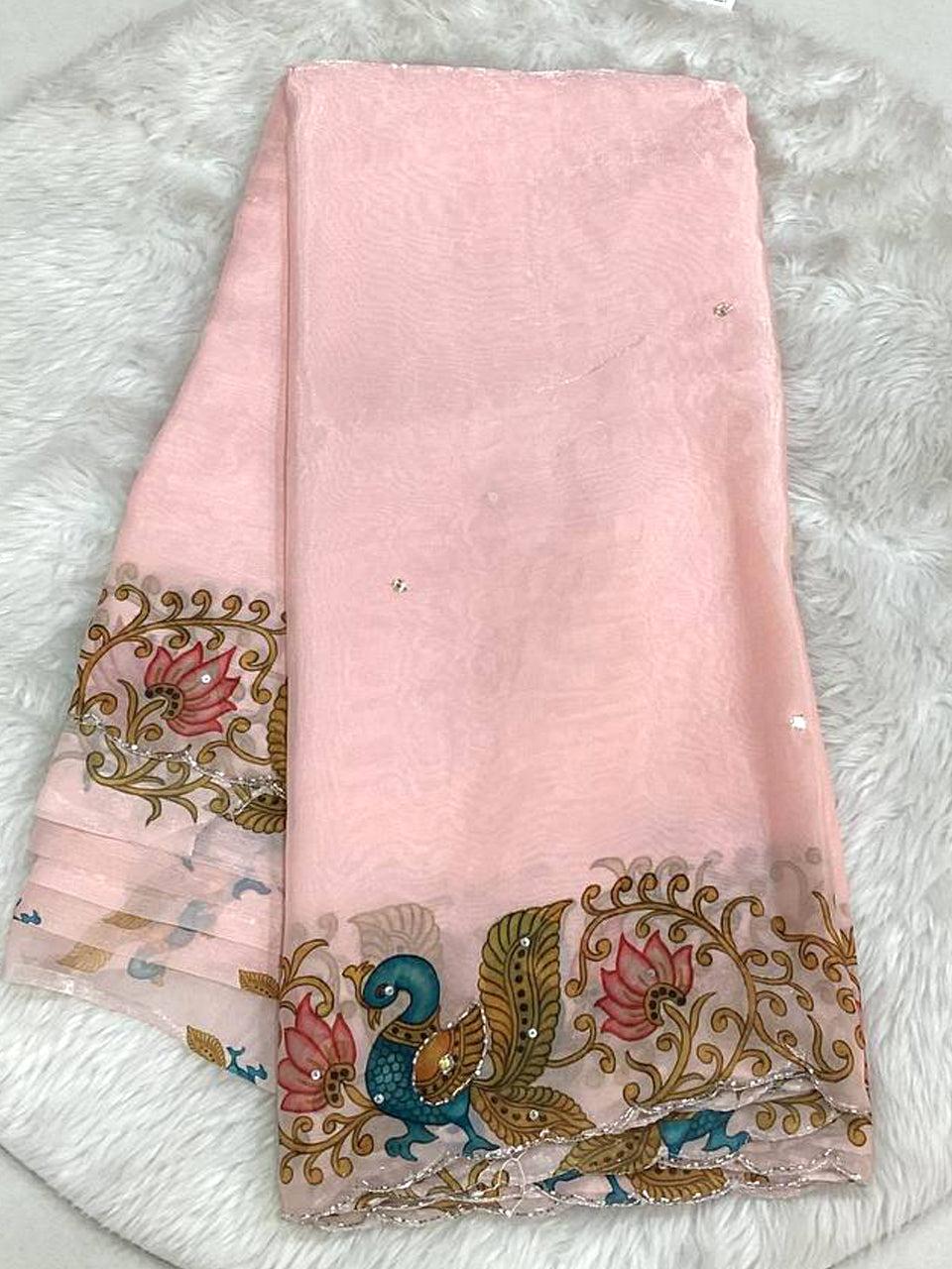Rose pink space silk saree with a designer cutwork scalloped border, traditional peacock motifs, and delicate small bead work.