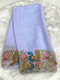 Lavender space silk designer saree featuring a multicolored peacock motif cutwork border and scattered small bead work butas.