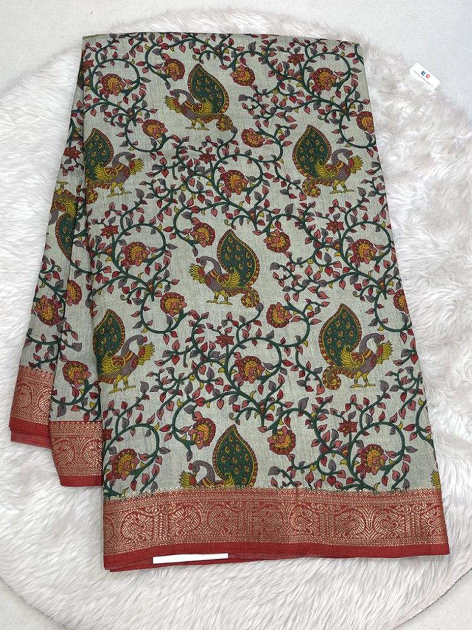 Vibrant magenta pink Icon Silk saree with all-over floral and bird embroidery and a detailed silver scalloped border.