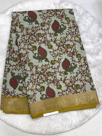 Earthy beige Tuna Silk saree with mustard yellow Kalamkari floral prints and a mustard contrast zari border.