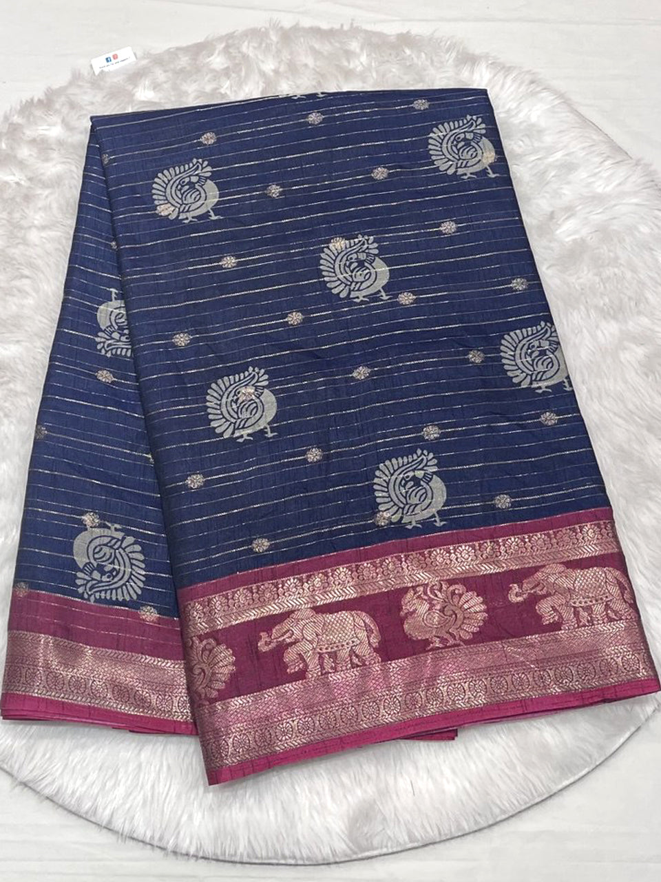 Navy blue tussar soft silk saree with pink neem zari border.