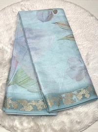 Sky blue Kota saree with abstract watercolor digital art and a shimmering woven Zari border