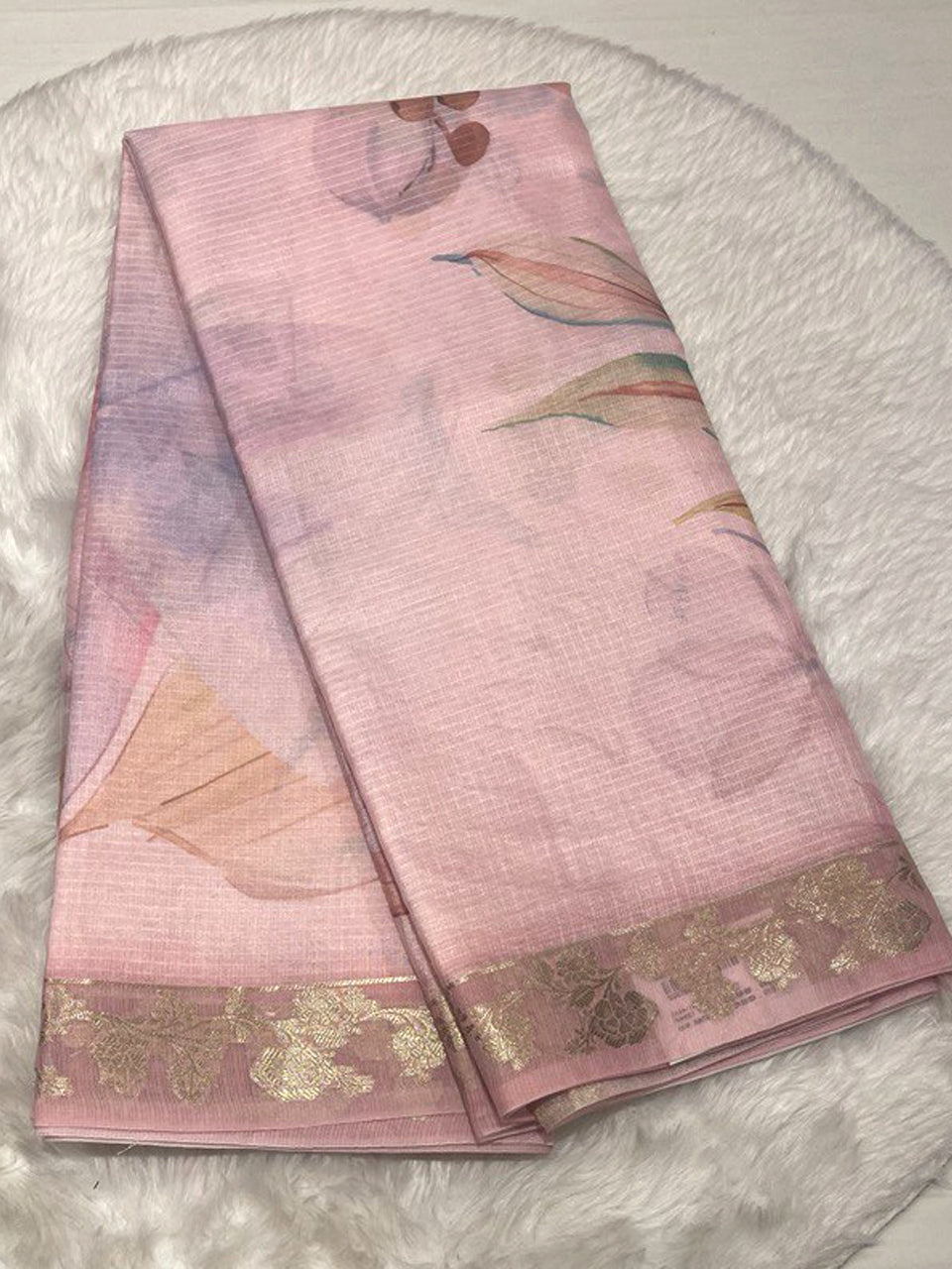 Soft pink Zari Kota silk saree with large watercolor floral prints and an elegant gold embroidered border